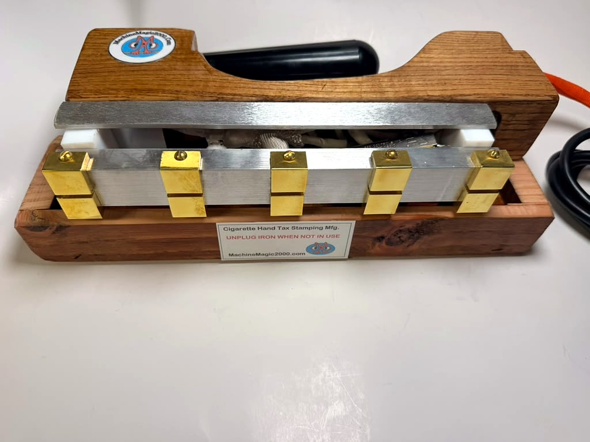 MM 10DLX Deluxe ten-stamp iron resting in its wooden stand