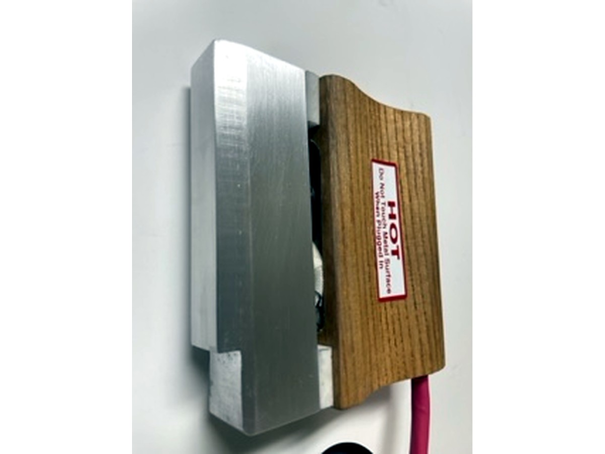 MM 5M four inch bar iron seen from the side, with the aluminum stamping head along its full length
